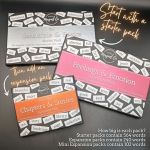 May include: Three boxes of magnetic word tiles for children. The boxes are labeled "Essentials & Basics", "Feelings & Emotion", and "Chapters & Stories". The boxes are pink, orange, and silver. The text on the boxes says "Start with a starter pack", "Then add an expansion pack", and "The Mini Expansion Pack".