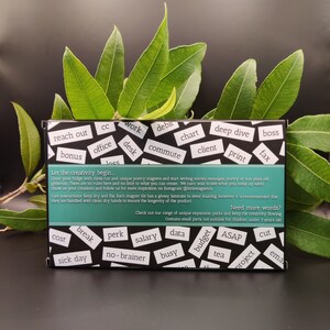 May include: A set of black magnetic tiles with white text. The tiles feature words like "reach out", "bonus", "work", "desk", "debit", "chart", "commute", "deep dive", "client", "print", "boss", "fax", "cost", "break", "perk", "salary", "data", "budget", "ASAP", "tea", "project", "cut", "sick day", "no-brainer", "busy", and "email". The text "Let the creativity begin" is printed on the top of the set. The text "Need more words?" is printed on the bottom of the set. The text "Check out our range of unique expansion packs and keep the creativity flowing" is printed below the text "Need more words?". The text "Contains small parts, not suitable for children under 3 years old" is printed below the text "Check out our range of unique expansion packs and keep the creativity flowing".