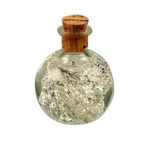 May include: A small, round glass bottle with a cork stopper. The bottle is filled with silver flakes.