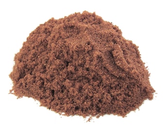May include: A pile of loose, dark brown, finely ground powder.