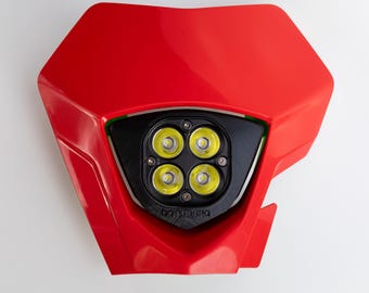 May include: A red motorcycle headlight assembly with four bright LED lights. The headlight has a black center section and the text "DO FUTURO" is visible. The housing is a vibrant red color.