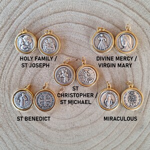 May include: Assortment of ten gold-toned pendants with silver-toned religious imagery. The pendants feature images of the Holy Family, St. Joseph, Divine Mercy, Virgin Mary, St. Benedict, St. Christopher, St. Michael, and Miraculous.