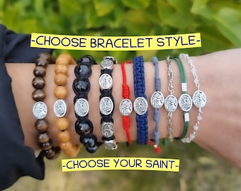 May include: A variety of bracelet styles featuring different materials, including wood, black beads, string, and metal. Each bracelet has a silver charm with a religious figure. The text "Choose Bracelet Style" and "Choose Your Saint" is displayed on the image.