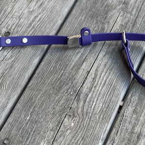 May include: Purple dog leash with a silver clip and a silver loop. The leash is made of a soft, flexible material.