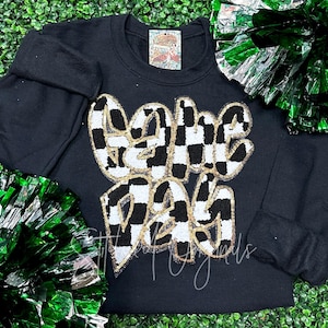 May include: Black sweatshirt with a checkered and gold sequined "Game Day" graphic.