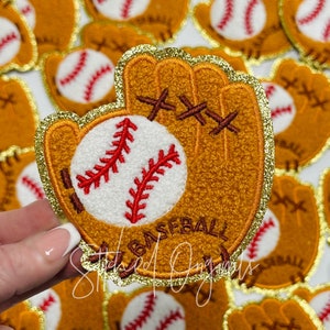 May include: A gold glitter-trimmed felt patch with a brown baseball glove and a white baseball with red stitching. The patch says "Baseball" in brown letters.