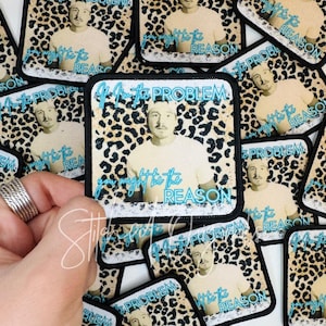 May include: Square patch featuring a man in a white t-shirt with the text "If you might be the PROBLEM" in turquoise. The background is a leopard print. Patches are scattered on a surface.
