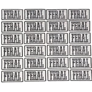 May include: Twenty-four white rectangular patches with black embroidered text that reads "FERAL" repeated.