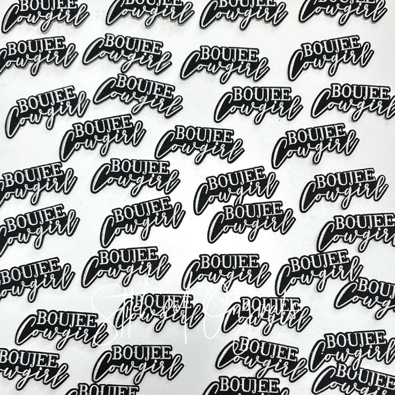 May include: A close-up of multiple black and white iron-on patches with the text "BOUJEE COWGIRL" repeated on each patch.
