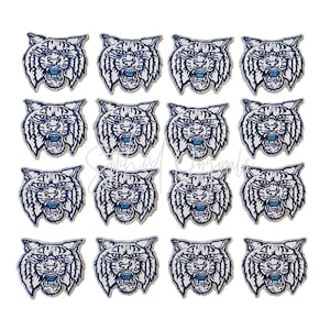 May include: Sixteen embroidered patches featuring a snarling bobcat head. The patches are white with blue accents and a silver-gray border. The bobcat's mouth is open, revealing its teeth. The patches are arranged in a grid pattern against a white background.