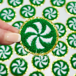 May include: Green and white peppermint swirl iron-on patch with a gold glitter trim. The patch is approximately 1.5 inches in diameter.