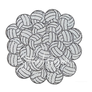 May include: A close-up of a group of black and white volleyball-shaped embellishments. The embellishments are made of rhinestones and are arranged in a circular pattern.
