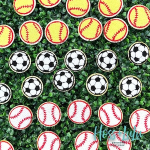 May include: A collection of felt patches featuring different sports, including baseball, softball, and soccer. The patches are all round and have a gold glitter outline. The patches are arranged on a green background.