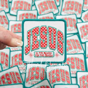 May include: A teal blue square patch with white fabric and red and white checkered lettering that reads "JESUS IS THE REASON FOR THE SEASON".