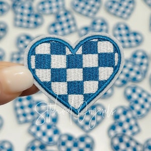May include: A blue and white checkered heart-shaped patch. The patch is made of fabric and has a white outline. The patch is perfect for adding a touch of personality to your clothing or accessories.