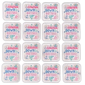 May include: Set of 16 white square iron-on patches with a nautical theme. Each patch features a pink and blue anchor with the text "Anchor Down Bottoms Up" in a white font.
