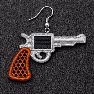 May include: Embroidered gun-shaped earring with a silver-colored outline and a black center. The handle is a dark orange color with a diamond pattern. The earring has a silver-colored hook.