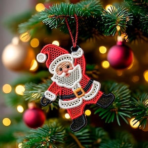 May include: A red and white Santa Claus Christmas ornament with a black belt and boots, hanging from a red string. The ornament is made of a lace-like material and is hanging on a Christmas tree with red and gold ornaments.