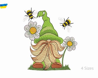 May include: Embroidered design of a green gnome with a brown beard, wearing a green hat and standing in front of a white daisy with two yellow bees flying around. The design is available in four sizes.