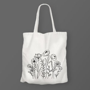 Op de afbeelding: Witte canvas tote bag met een zwarte lijntekening van een boeket bloemen.