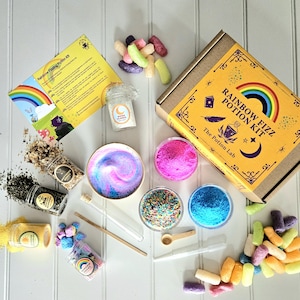 May include: A rainbow fizz potion kit with a yellow box that says "Rainbow Fizz Potion Kit" and "The Potion Lab". The kit includes a variety of ingredients, including colorful sprinkles, powders, and a small bottle of moonflower.