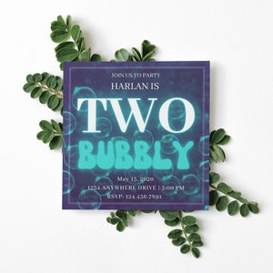 May include: A blue and purple invitation with a white background. The invitation says "Join us to party Harlan is Two Bubbly" with a date and time. The background is filled with blue and white bubbles.