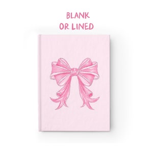 May include: A pink notebook with a pink bow on the front. The notebook says "BLANK OR LINED" in pink text.