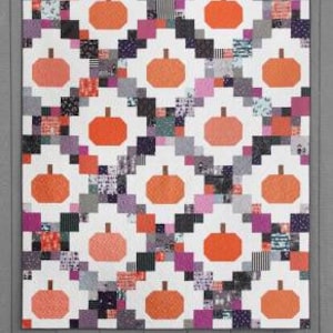 May include: A quilting pattern called "Pumpkin Patches" with a white background and a patchwork design of orange pumpkins, black and white squares, and pink and purple squares. The pattern is made with fat quarters, 5-inch squares, or 10-inch squares.