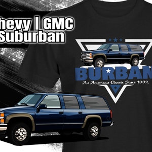 May include: A black t-shirt with a blue and white graphic of a Chevy or GMC Suburban. The graphic includes the text "BURBAN An American Classic Since 1992".