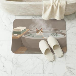 May include: A bath mat featuring a cartoon cat relaxing in a hot tub. The mat has a neutral color scheme with a gray tub, green accents, and white slippers. A towel hangs above the tub.