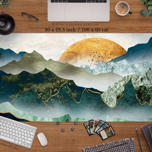 May include: A green, blue, and gold abstract mountain landscape with a golden sun in the background. The design is printed on a white background. The text "www.charmedville.com" and "40 x 23.5 inch / 100 x 60 cm" is printed in black at the top of the image.