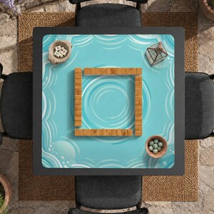 May include: Overhead view of a square Mahjong table set for play. The table has a light blue surface with a water wave design. Wooden tiles form a square in the center. Small bowls and a glass terrarium are on the table.