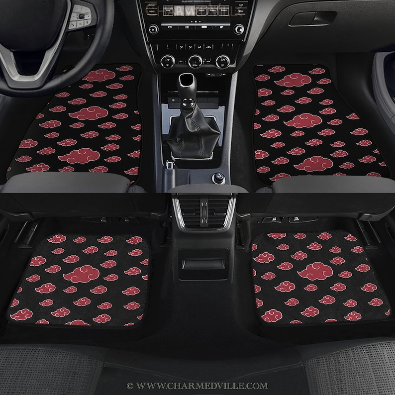 May include: A set of four black car floor mats with a red cloud pattern. The mats are designed to fit in a car with a standard driver's side, passenger side, and two back seats.