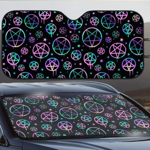 May include: A black car sunshade with a repeating pattern of iridescent pentagrams and stars. The pentagrams are outlined in white and have a dripping effect. The stars are small and scattered throughout the design.
