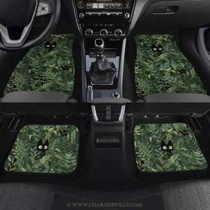 May include: Set of four car floor mats with a green leafy pattern and black cat silhouettes. The mats are made of a durable material and are designed to protect your car's interior.