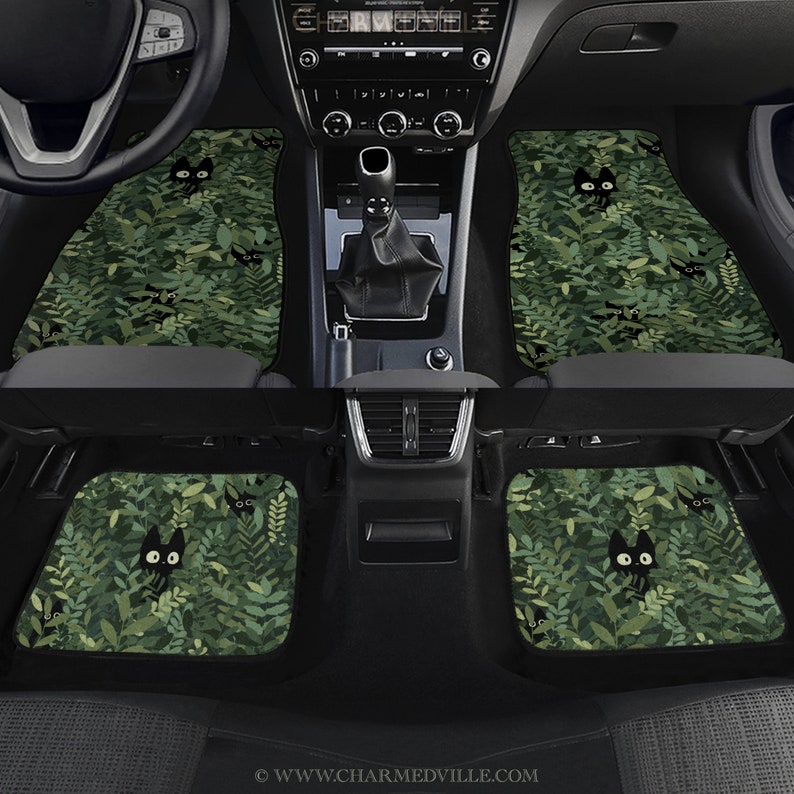 May include: Set of four car floor mats with a green leafy pattern and black cat silhouettes. The mats are made of a durable material and are designed to protect your car's interior.