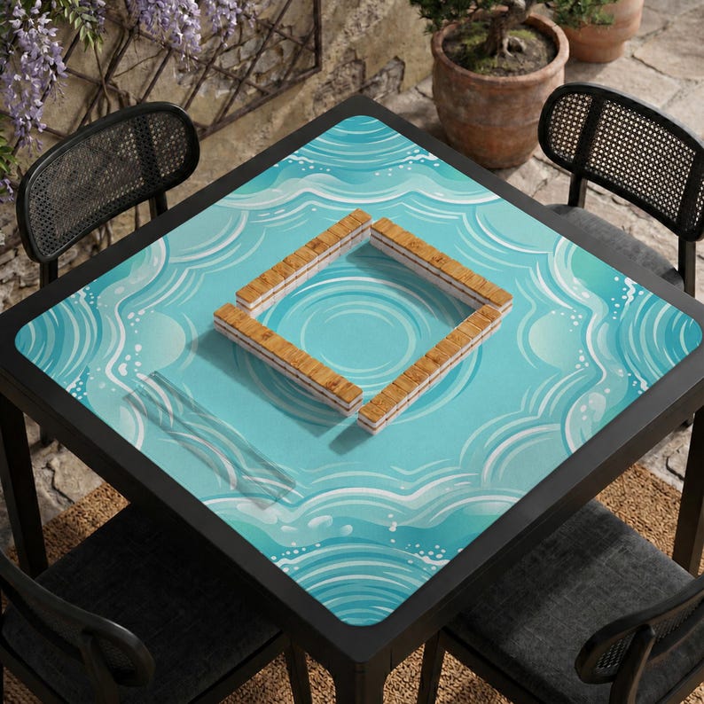 May include: A square black table with a light blue surface featuring a water wave design. Four wooden Mahjong tiles are arranged in a square on the table. Two black chairs are on either side of the table.
