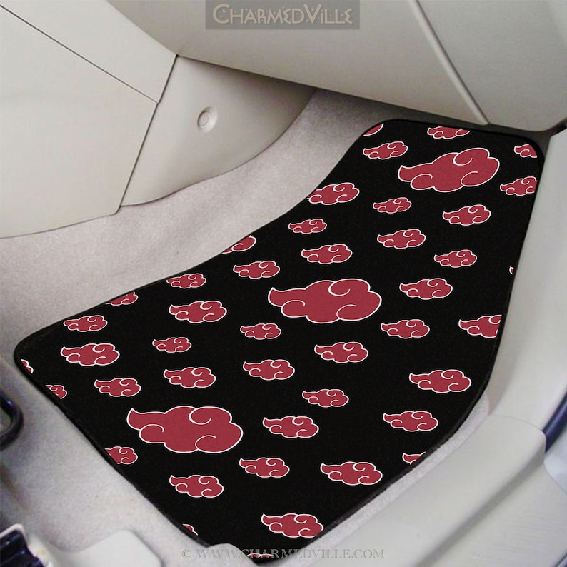 May include: Black car floor mat with a red cloud pattern. The clouds are stylized and have a white outline.