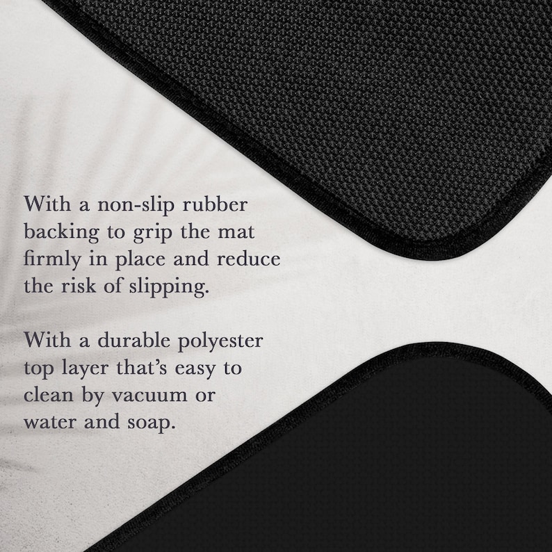 May include: A black floor mat featuring a textured non-slip rubber backing and a durable polyester top layer. The text reads: With a non-slip rubber backing to grip the mat firmly in place and reduce the risk of slipping. With a durable polyester top layer that's easy to clean by vacuum or water and soap.