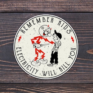 May include: A white circle sticker with a red border and the text "Remember Kids Electricity Will Kill You" in black. The sticker features a cartoon character with a lightning bolt for hair holding a knife and a second cartoon character with a red and black plaid shirt.