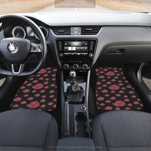 May include: Black car floor mats with a red cloud pattern. The mats are in the front passenger and driver's side of the car. The mats are made of a soft, durable material and are easy to clean.