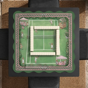 May include: A square game board with a tennis court design, featuring cartoon rabbits playing tennis. The board has a green and pink border and is surrounded by a black frame. White game pieces are arranged in a square in the center.
