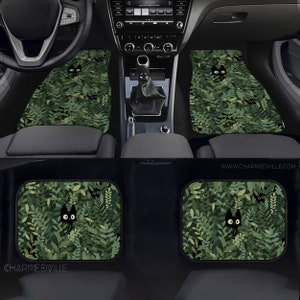 May include: Green car floor mats with a black cat peeking out from behind green leaves. The mats feature a repeating pattern of cats and leaves. The text "www.charmedville.com" is visible in the bottom right corner of the image.