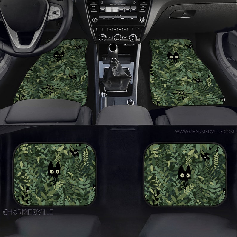 May include: Green car floor mats with a black cat peeking out from behind green leaves. The mats feature a repeating pattern of cats and leaves. The text "www.charmedville.com" is visible in the bottom right corner of the image.