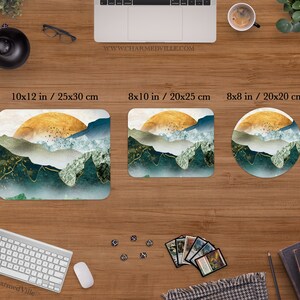 May include: Three different sizes of mousepads featuring a landscape design with a gold sun, blue and green mountains, and white clouds. The mousepads are available in 10x12 inches, 8x10 inches, and 8x8 inches.
