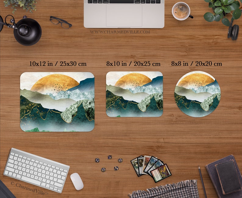 May include: Three different sizes of mousepads featuring a landscape design with a gold sun, blue and green mountains, and white clouds. The mousepads are available in 10x12 inches, 8x10 inches, and 8x8 inches.