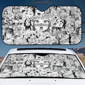 May include: Black and white car sunshade featuring a collage of manga-style faces. The sunshade is displayed in front of a white car, with the text "CHARMEDVILLE" visible at the top. The design is repeated on the car's windshield.