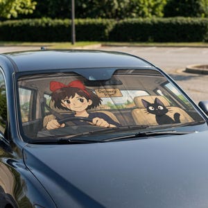 May include: Car windshield sunshade featuring an anime-style illustration. The design includes a girl with a red bow driving a car, a black cat, and a sign that reads "Delivery Run". The sunshade is designed to fit a car windshield.
