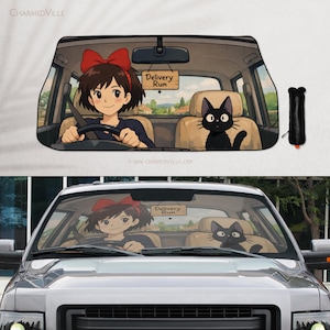 May include: Car windshield sunshade featuring an anime-style illustration of a girl driving a car with a black cat in the passenger seat. The sign reads "Delivery Run". The sunshade is black and has a matching storage sleeve.