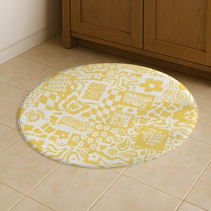 Könnte beinhalten: Ovaler gelb-weißer Badteppich mit Patchwork-Design. Der Teppich zeigt verschiedene Muster, darunter Blumen, Smiley-Gesichter und Schachbrettquadrate. Der Text enthält "Positive Vibes Only" und "It's a good day to have a good day."